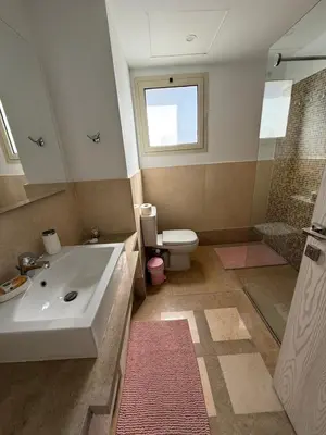 a bathroom with a sink and a shower and a toilet at Elite 3bdr apartment with garden beside corral reef in Hurghada