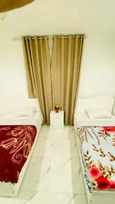 two beds sitting next to each other in a room at Menna guest house in Luxor