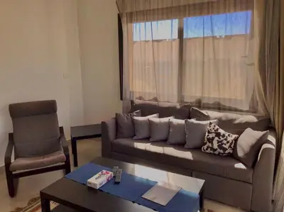 a living room with a couch and a chair at Stunning 1-Bedroom in G Cribs in Hurghada