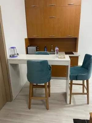 a kitchen with two chairs and a table and a sink at Luxurious One Bedroom Apartment in Hurghada