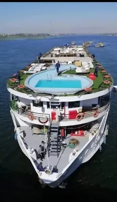 a cruise ship with a swimming pool on the water at Hamoo guest House hotel in Aswan