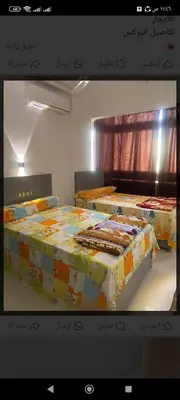 two beds sitting in a room with a tv at Hamoo guest House hotel in Aswan