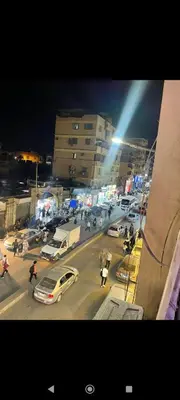 a busy city street at night with cars and people at Hamoo guest House hotel in Aswan