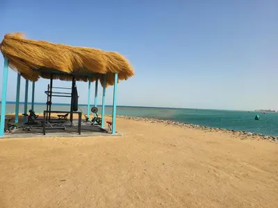a straw hut on a beach with the ocean at Mangroovy- 1br Imposing, Relaxing & Sea View in Hurghada