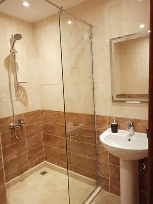 a bathroom with a shower and a sink at Avenue Alhambra in Hurghada