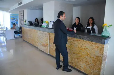 a man in a suit standing at a counter at Beachfront Boho Style apartment in Fanadir Bay in Hurghada
