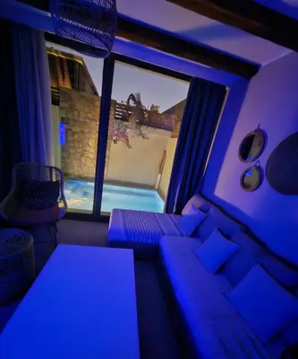 a living room with a couch and a swimming pool at one bedroom in gouna in Hurghada