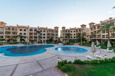 a large apartment complex with a large swimming pool at Resort-Style Luxury Chalet with Pool and Sea View in Sahl Hasheesh in Hurghada