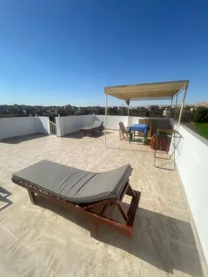 a bed on the roof of a house at Flat in Kom in Luxor