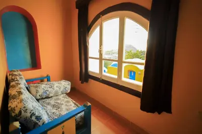 a room with a couch and a large window at Nubiano Cataract in Shellal