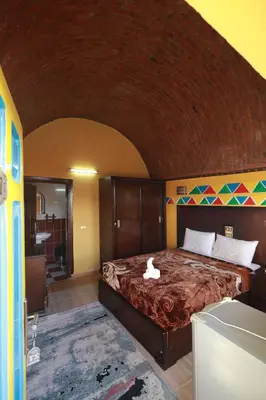 a bedroom with a bed with a white duck on it at Nubiano Cataract in Shellal