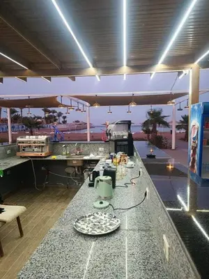 a kitchen with a counter with plates on it at منتجع سكانديك in Hurghada