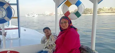 two women sitting on a boat with a soccer ball at Queen Sophie in Luxor