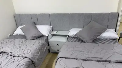 two beds sitting next to each other in a room at Serenity Cozy Studio Direct to the Pool In Hurghada in Hurghada