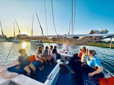 a group of people sitting on a boat in the water at Alex in Luxor