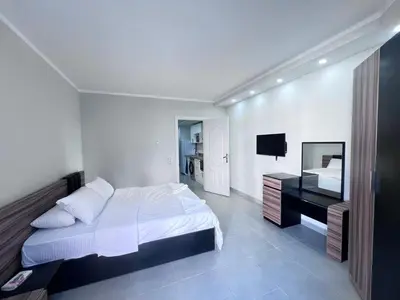 a white bedroom with a bed and a desk at Scandic Hotel Hurghada in Hurghada