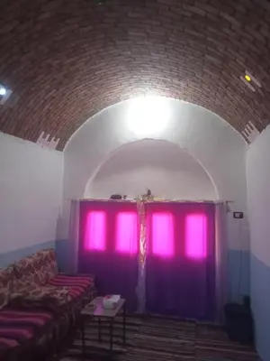 a room with purple curtains and a couch at Nubian dream house in Jazīrat Fīlah