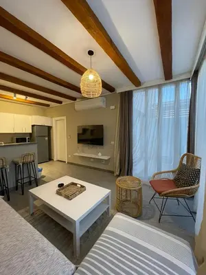 a living room with a couch and a table at Luxury one bedroom in Hurghada