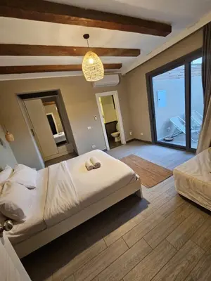 a bedroom with a large bed and a large window at Luxury one bedroom in Hurghada