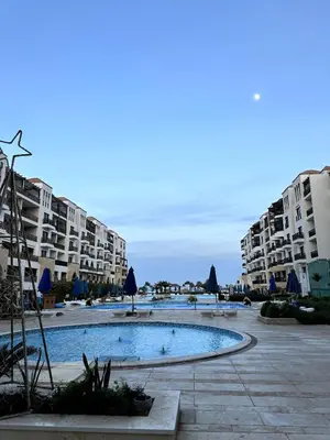 a large swimming pool in front of some apartment buildings at studio in a 5 star hotel in Hurghada