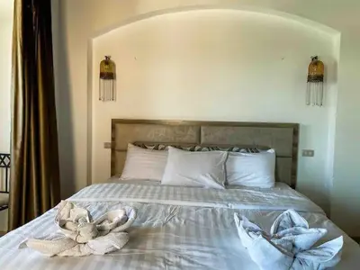 a bedroom with a bed with towels on it at Luxury villa west golf in Hurghada