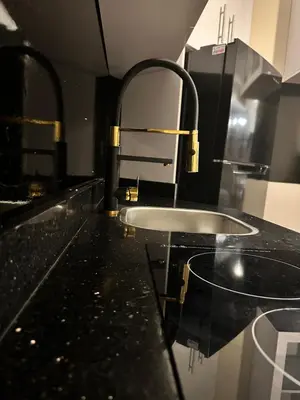 a bathroom with a black counter top with a sink at The best Studio in Hurghada
