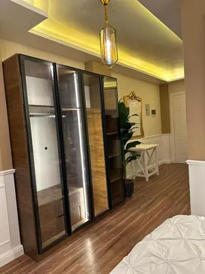 a bedroom with a large glass closet in a room at The best Studio in Hurghada