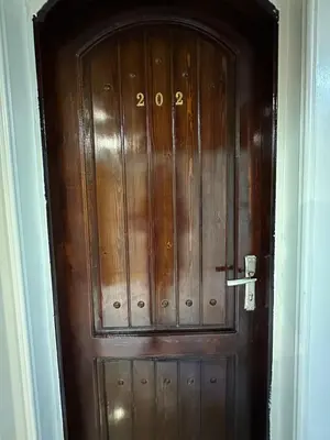 a wooden door with the number on it at Nubian Soul Guest Houses in Aswan