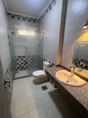 a bathroom with a sink and a toilet and a shower at Sky star 135 in Hurghada