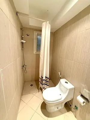 a bathroom with a toilet and a shower at Amazing 2BR Apartment - Al Dora Resort, Hurghada in Hurghada