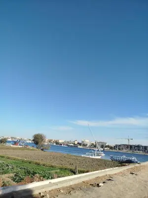 a view of a river with a boat in the water at Dolphin guest house in Jazīrat al ‘Awwāmīyah