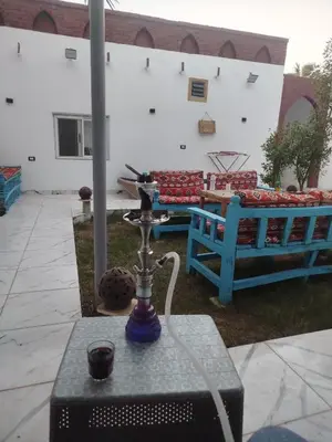 a patio with a table with a candle on it at Dolphin guest house in Jazīrat al ‘Awwāmīyah