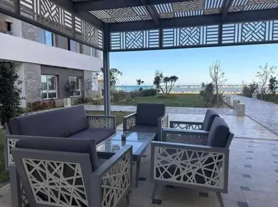a patio with couches and a table and chairs at Fanadir Bay Resort in Hurghada