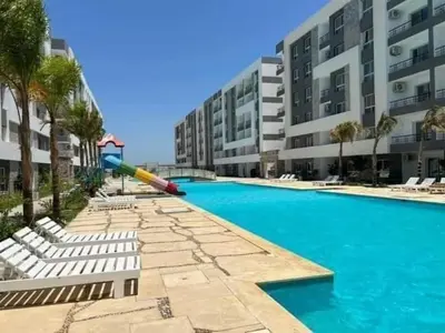a large swimming pool with a large building at Fanadir Bay Resort in Hurghada