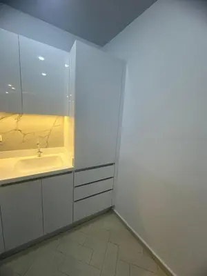 a white bathroom with a sink and a mirror at Al Saraya Sahl Hashish Serenity Chalet in Hurghada