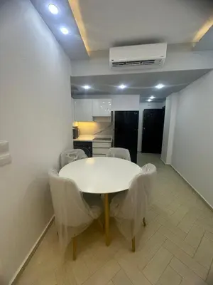 a dining room with a white table and chairs at Al Saraya Sahl Hashish Serenity Chalet in Hurghada