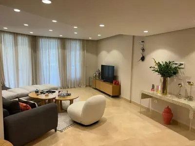 a living room with a couch and a table at Sea View Haven at Mangroovy in Hurghada