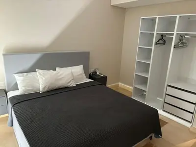 a bedroom with a large black bed with white pillows at Sea View Haven at Mangroovy in Hurghada
