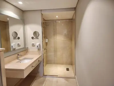a bathroom with a shower and a sink at Elgouna - Mangroovy 2BR - Pool & Sea view in Hurghada