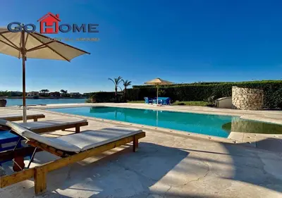 a swimming pool with a bench and an umbrella at Stylish 4 BR with a Private Heated Pool V15 at White Villas in Hurghada