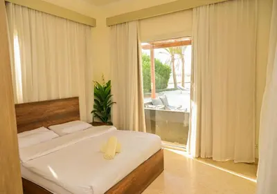 a bedroom with a bed with a yellow towel on it at Stylish 4 BR with a Private Heated Pool V15 at White Villas in Hurghada