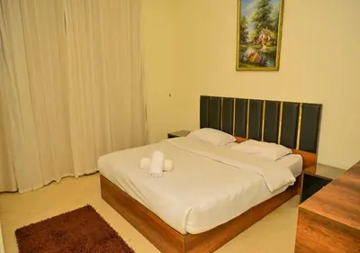 a bedroom with a bed with two white towels on it at Stylish 4 BR with a Private Heated Pool V15 at White Villas in Hurghada