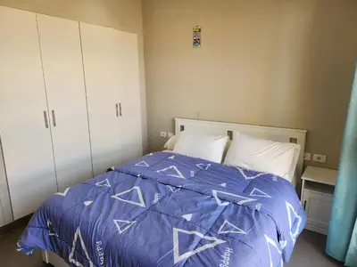 a bedroom with a bed with a blue comforter at Gouna - Tawila 1BR breathtaking lagoon & pool view in Hurghada