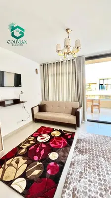 a living room with a couch and a rug at Cozy studio G-cribs in Hurghada