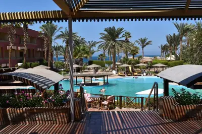 a pool at a resort with chairs and umbrellas at New Geisum Resort in Hurghada