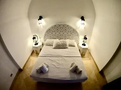 a bedroom with a bed and two night stands at Villa 3bedroom in new years in Hurghada