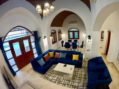 a living room with a blue couch and a table at Villa 3bedroom in new years in Hurghada