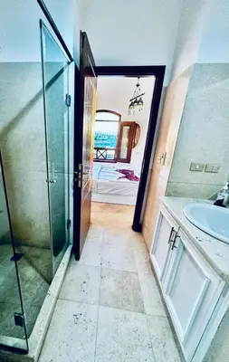 a bathroom with a glass shower and a sink at 2Bedroom in west golf in Hurghada