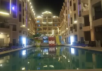 an empty swimming pool in a building at night at Juliana beach resort in Hurghada