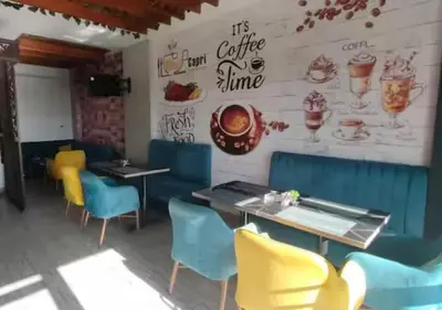 a restaurant with chairs and tables and a wall with ice cream at Juliana beach resort in Hurghada